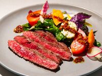 Carefully selected Okinawan  Japanese Black Wagyu beef rump tagliata with colorful seasonal vegetables and hot pancetta sauce