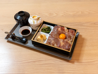A luxurious rice bowl with seared Wagyu beef and egg yolk.